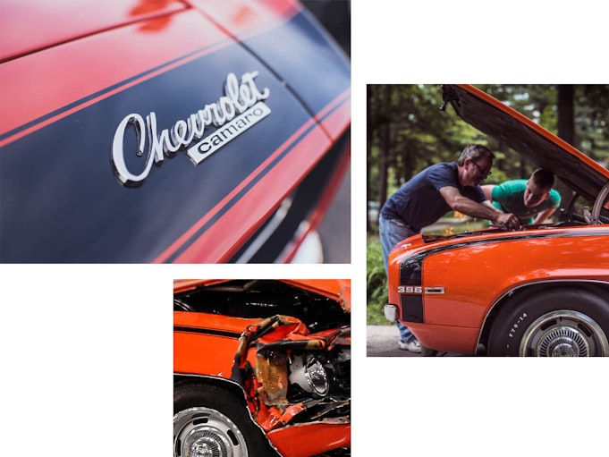 A man and his son pop up the hood of an orange Chevrolet Camaro to inspect the damage.