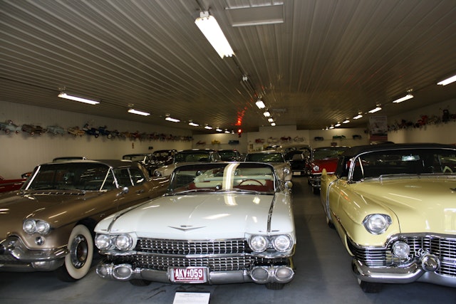 three vintage cars parked in garage