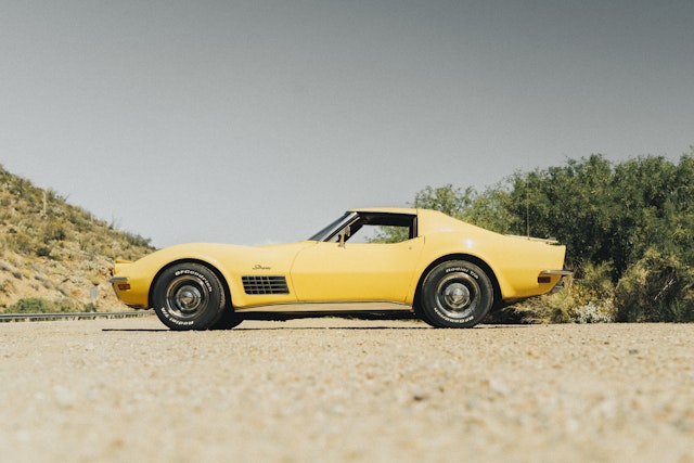yellow 1972 corvette parked on road