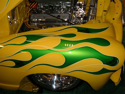 A close-up of a yellow collector vehicle with a green custom paint job