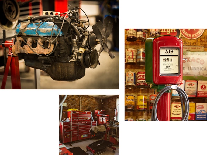 An engine, and air compressor, and storage cabinets sit inside of a garage.